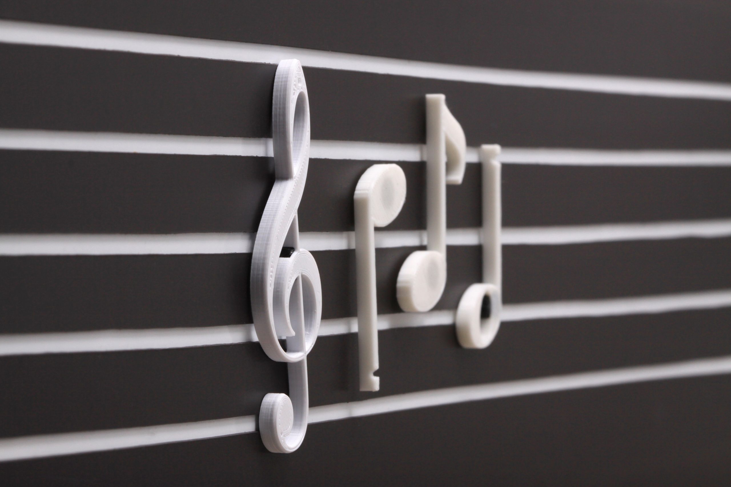 Close-up of recessed staff lines with 3D-printed treble clef and magnetic notes